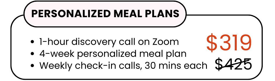 A woman in athletic wear sitting on a yoga mat indoors, smiling.