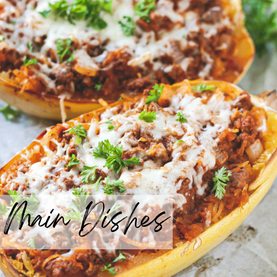 A woman in athletic wear sitting on a yoga mat indoors, smiling.