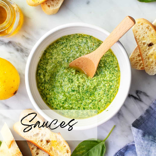 A woman in athletic wear sitting on a yoga mat indoors, smiling.