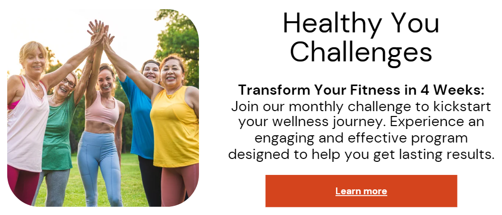 A woman in athletic wear sitting on a yoga mat indoors, smiling.