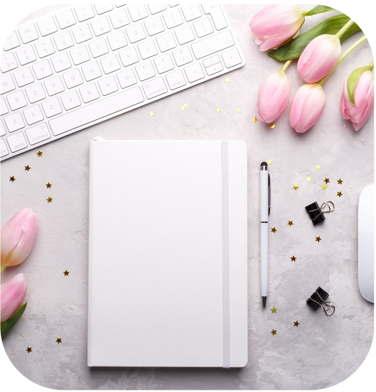 A woman in athletic wear sitting on a yoga mat indoors, smiling.